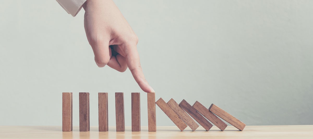 Finger pushing on wooden blocks